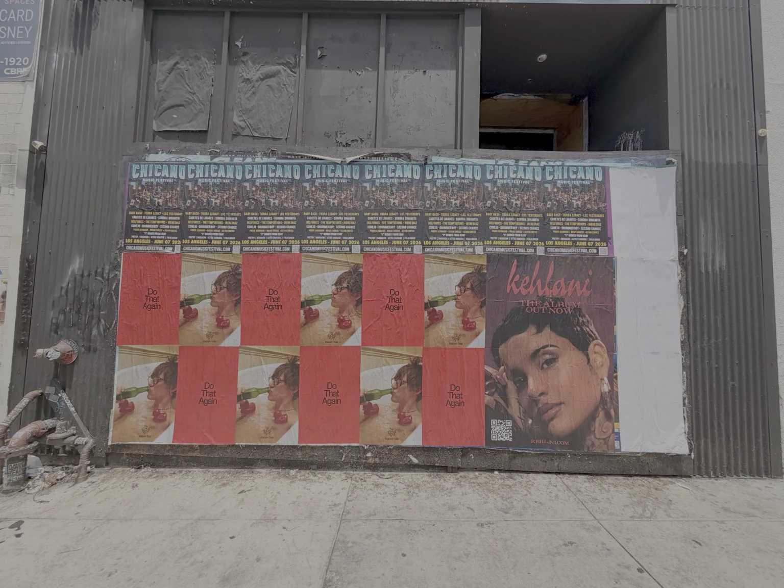 Multi-creative billboard poster grid on a street-facing wall