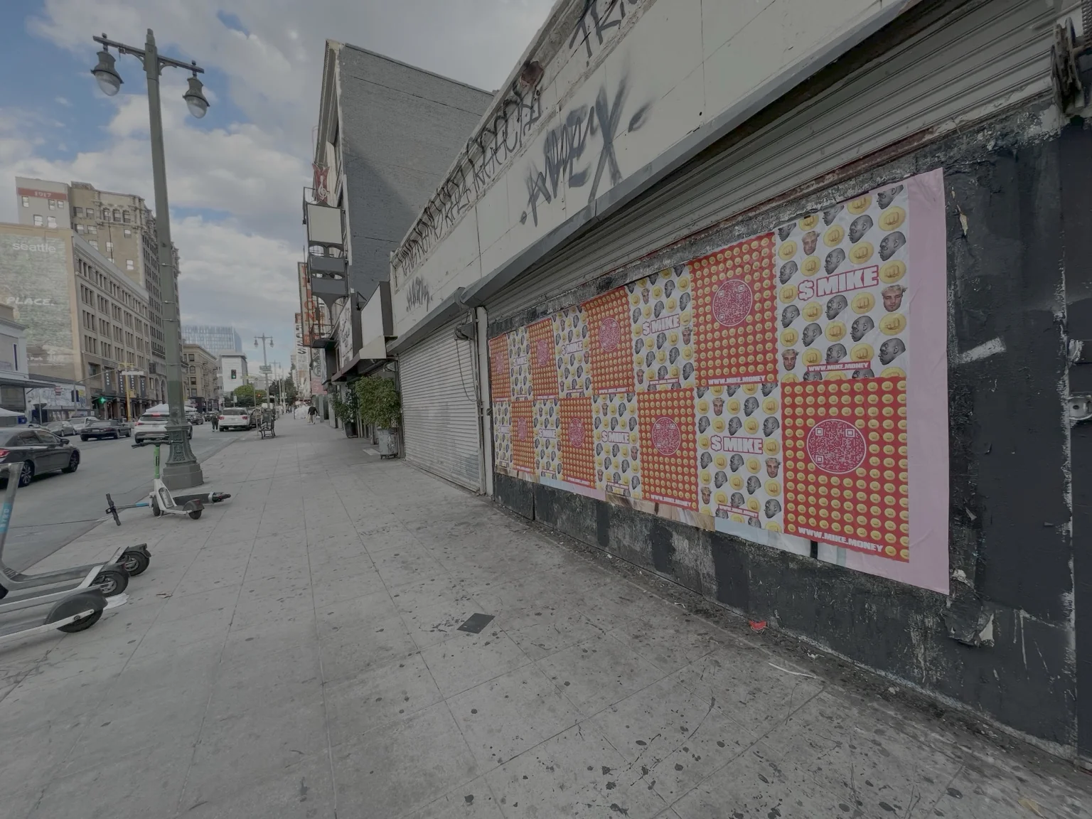 Colorful poster campaign installed along an urban sidewalk